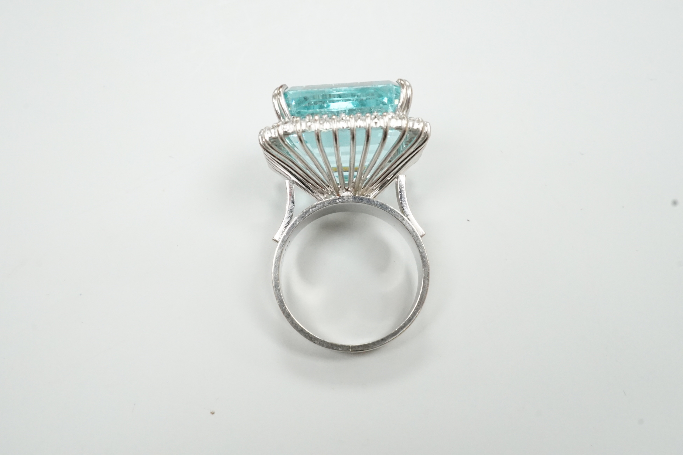 A modern 18ct white metal, simulated aquamarine and diamond chip cluster set dress ring, size P/Q, gross weight 16.3 grams